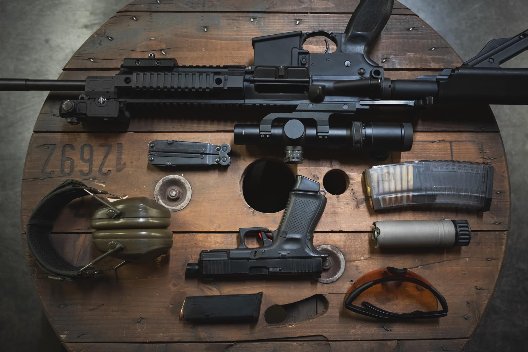 tactical weapons and gear on wood table