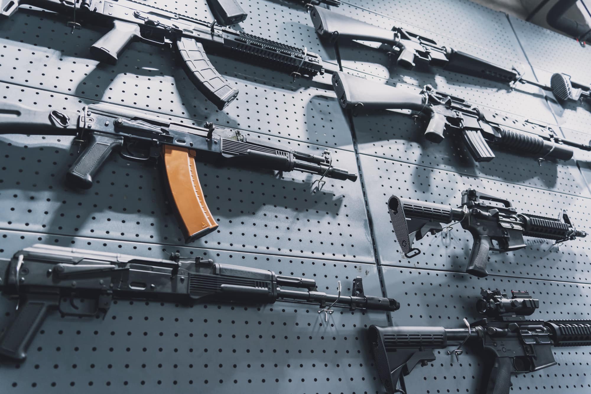 collection of rifles and carbines on the wall
